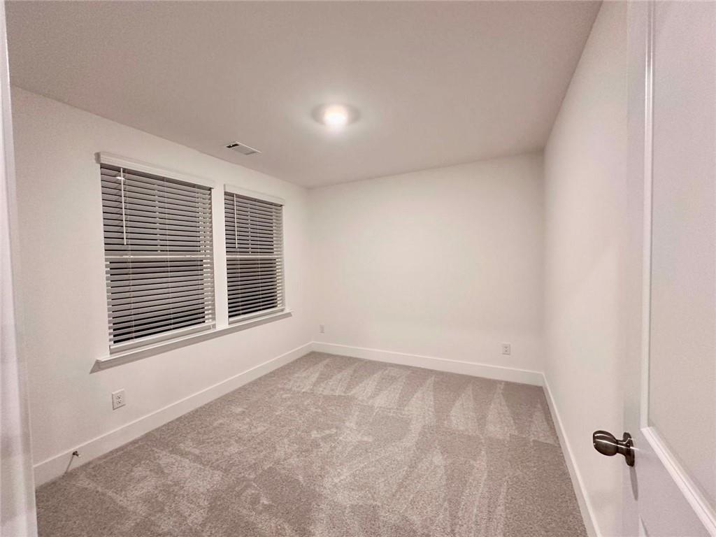 537 Hyde Rdg Trail Loganville, GA 30052 - Photo 8 of 23 a view of an empty room with a window