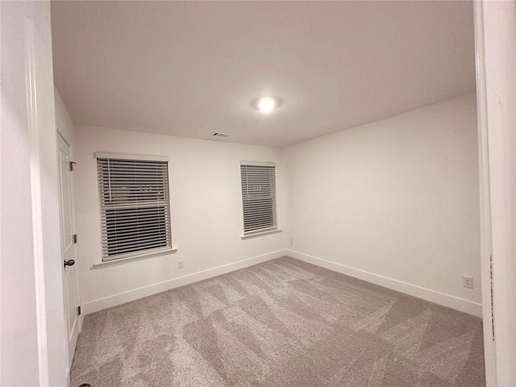537 Hyde Rdg Trail Loganville, GA 30052 - Photo 9 of 23 a view of an empty room with a window