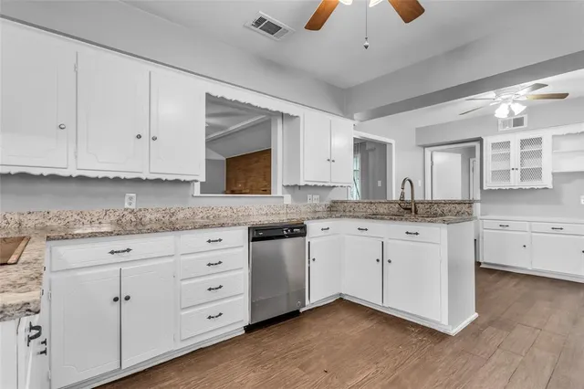 a kitchen with granite countertop cabinets stainless steel appliances and a counter space