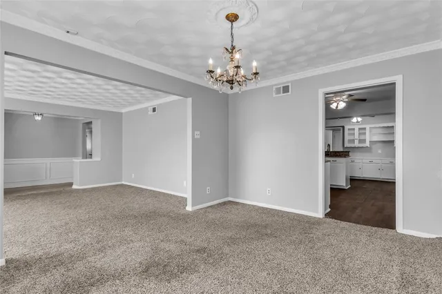 a front view of house with yard and trees in the background