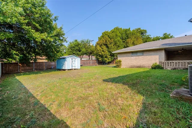 a view of a chair and table on the side of the house