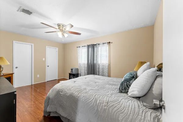 a bedroom with a bed and a chandelier