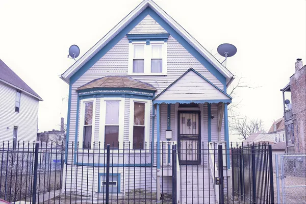 a view of a house with wooden fence