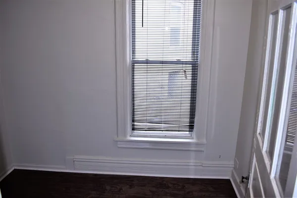 a view of wooden floor and a window