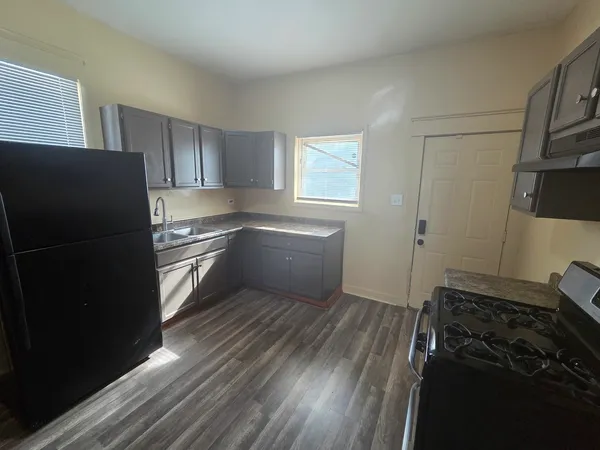 a kitchen with a refrigerator and a stove