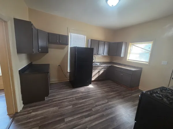 a kitchen with stainless steel appliances wooden cabinets and a refrigerator