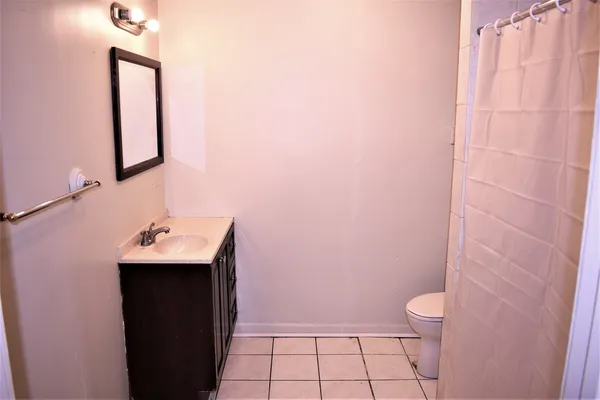 a bathroom with a sink a toilet and mirror