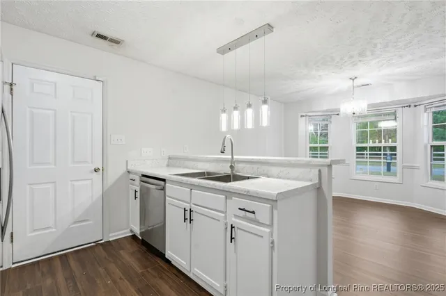 a kitchen with sink and cabinets
