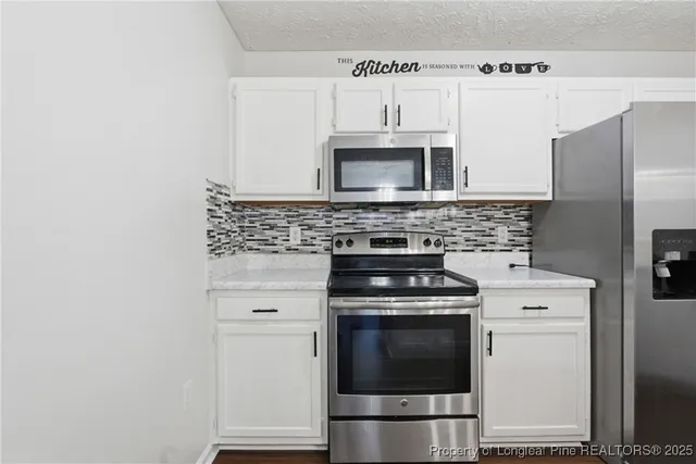 a kitchen with cabinets stainless steel appliances and wooden cabinets