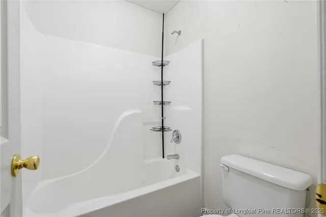 a bathroom with a shower and toilet