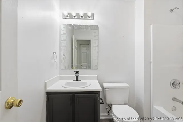 a white toilet sitting next to a bath tub and a shower