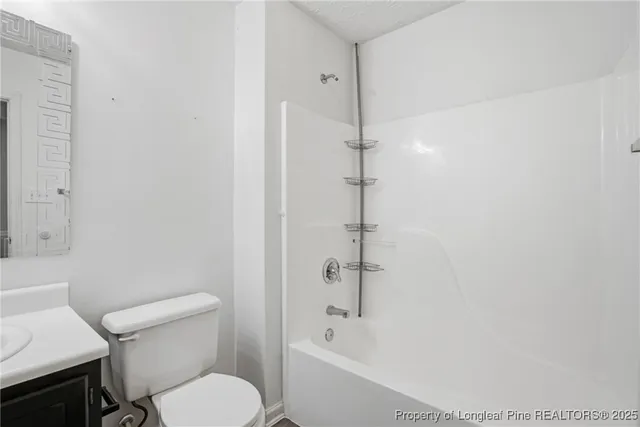 a bathroom with a sink toilet and mirror