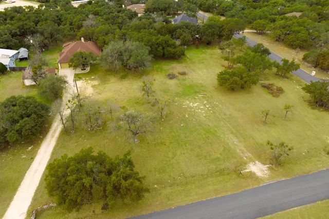 an aerial view of residential house with pool and yard