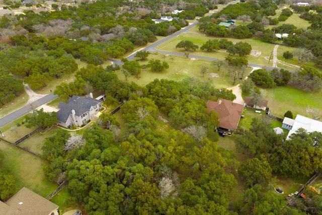 an aerial view of residential houses with outdoor space and mountain view