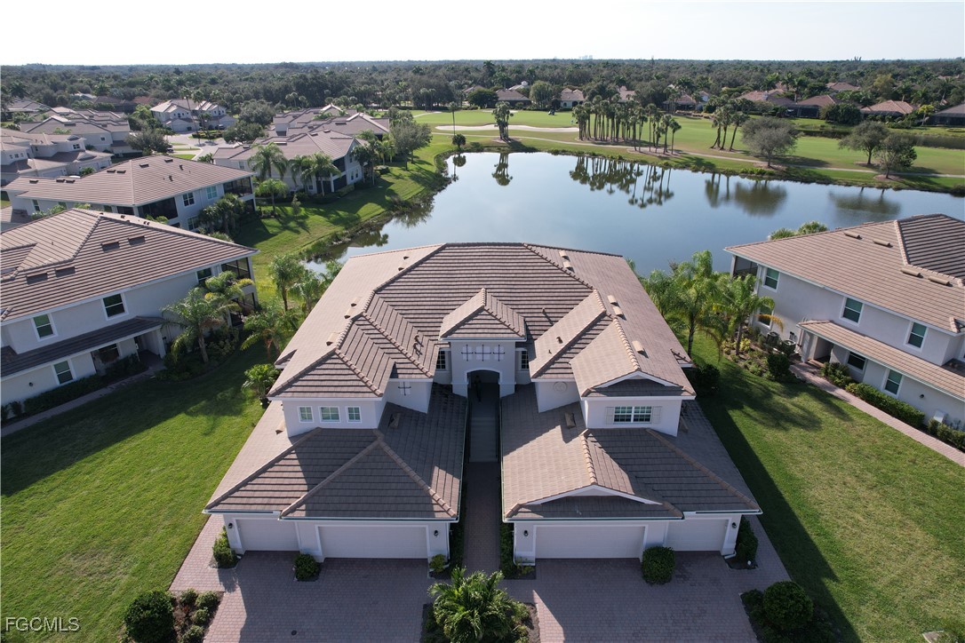 3771 Pebblebrook Ridge Court, Unit 201 Fort Myers, FL 33905 - Photo 2 of 45 an aerial view of a house with a yard and lake view