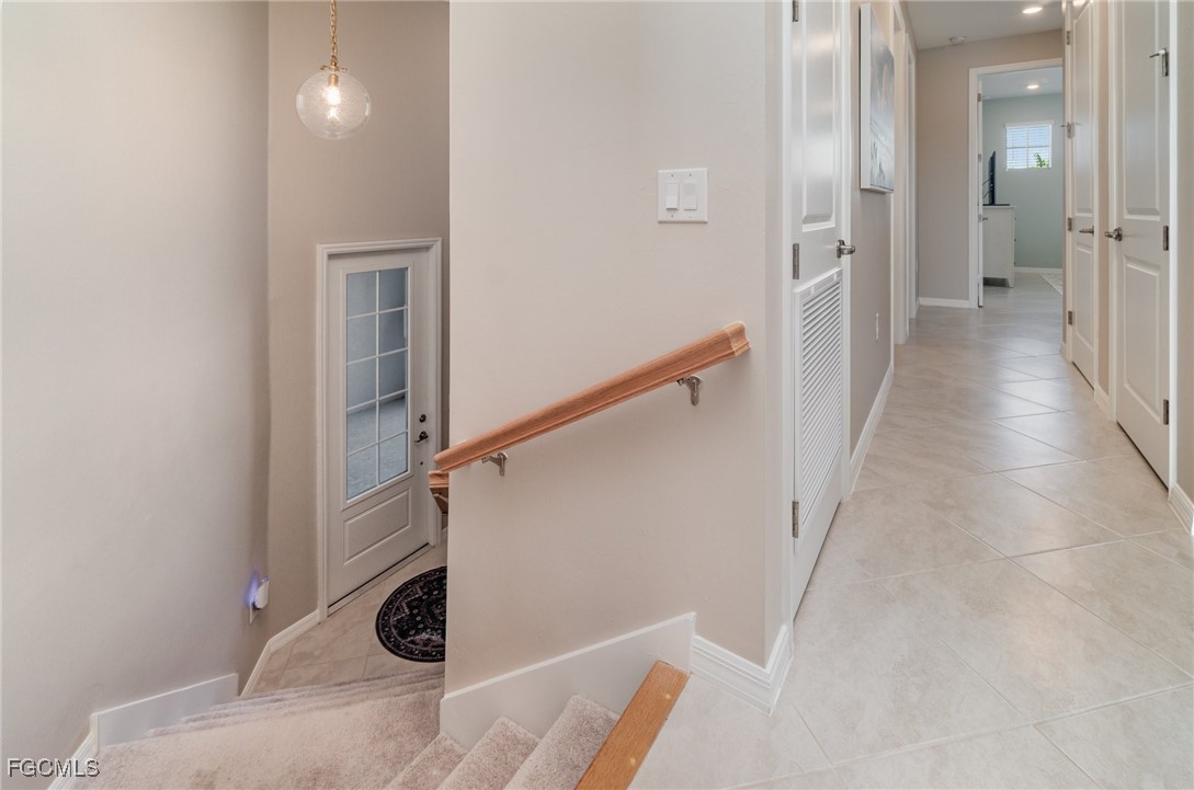 3771 Pebblebrook Ridge Court, Unit 201 Fort Myers, FL 33905 - Photo 4 of 45 a view of a hallway with wooden floor and staircase