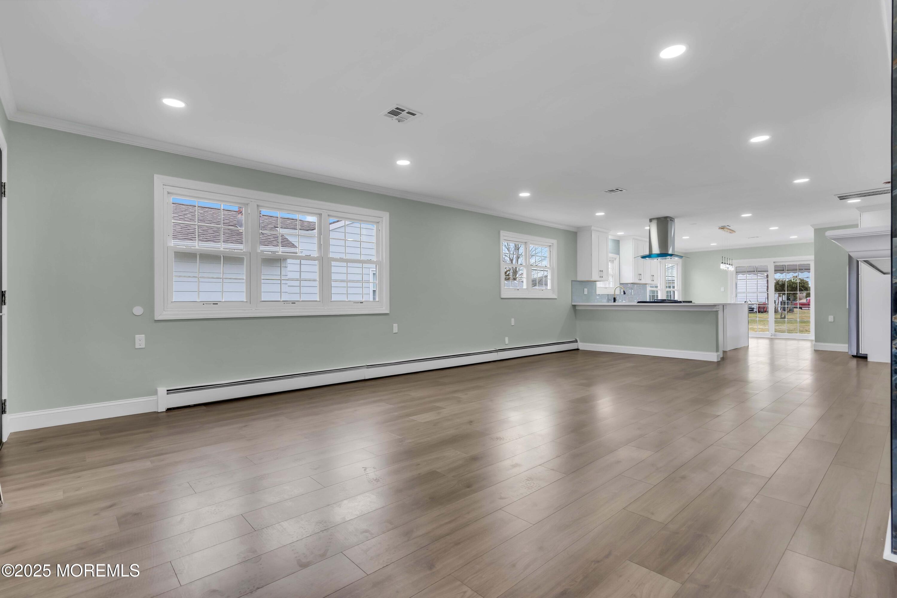 10 Aztec Court Toms River, NJ 08757 - Photo 20 of 57 an empty room with wooden floor and windows