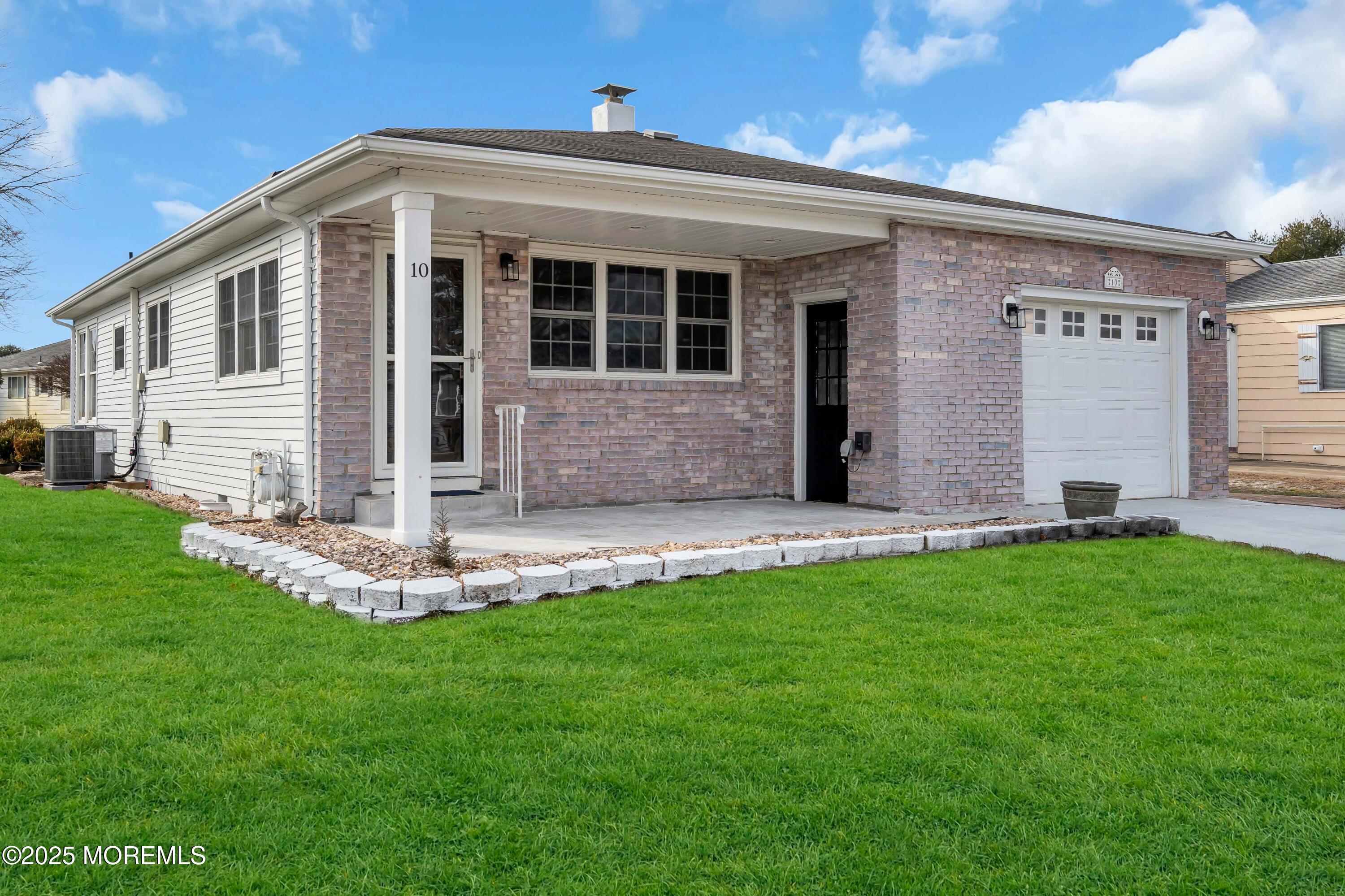 10 Aztec Court Toms River, NJ 08757 - Photo 2 of 57 a front view of house with a garden