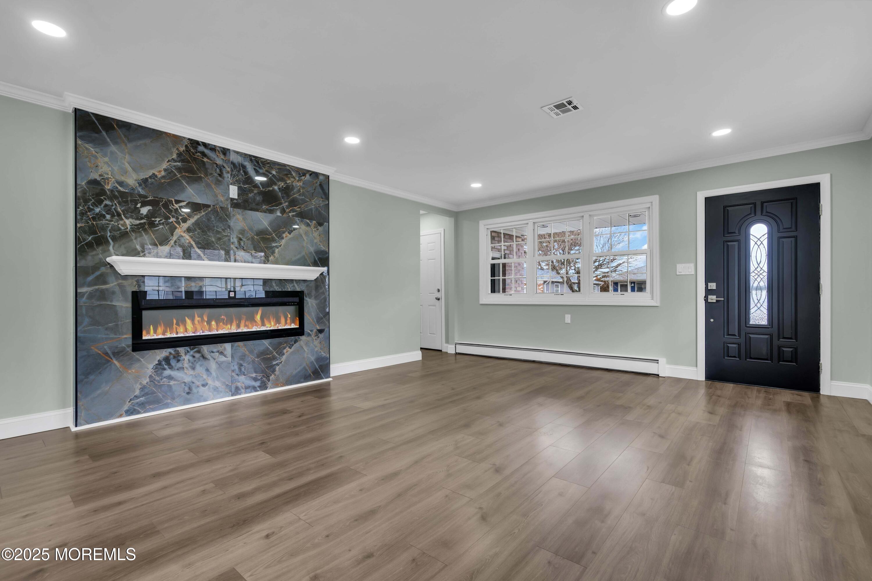 10 Aztec Court Toms River, NJ 08757 - Photo 23 of 57 a view of an empty room with wooden floor and a window