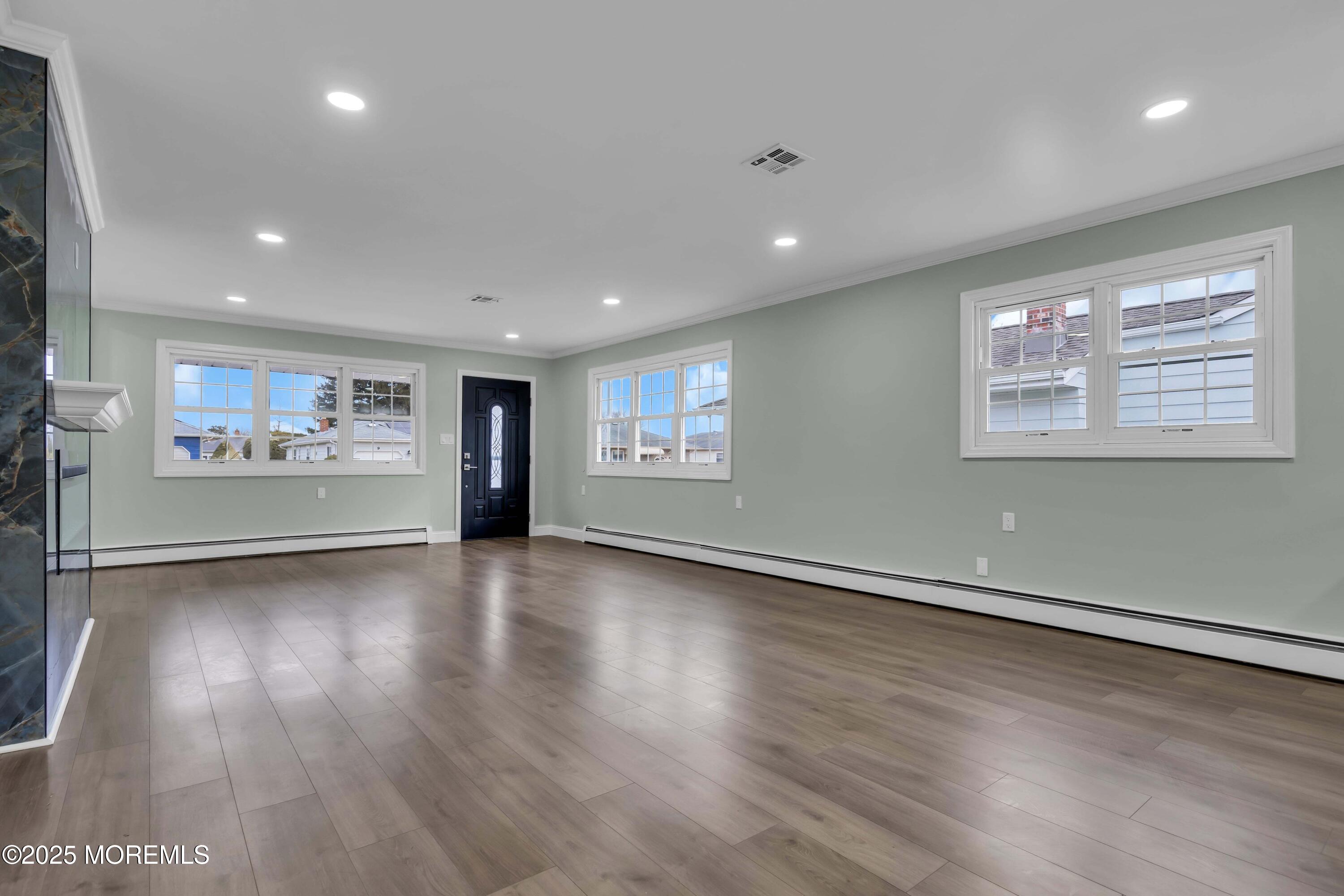 10 Aztec Court Toms River, NJ 08757 - Photo 27 of 57 an empty room with wooden floor and windows