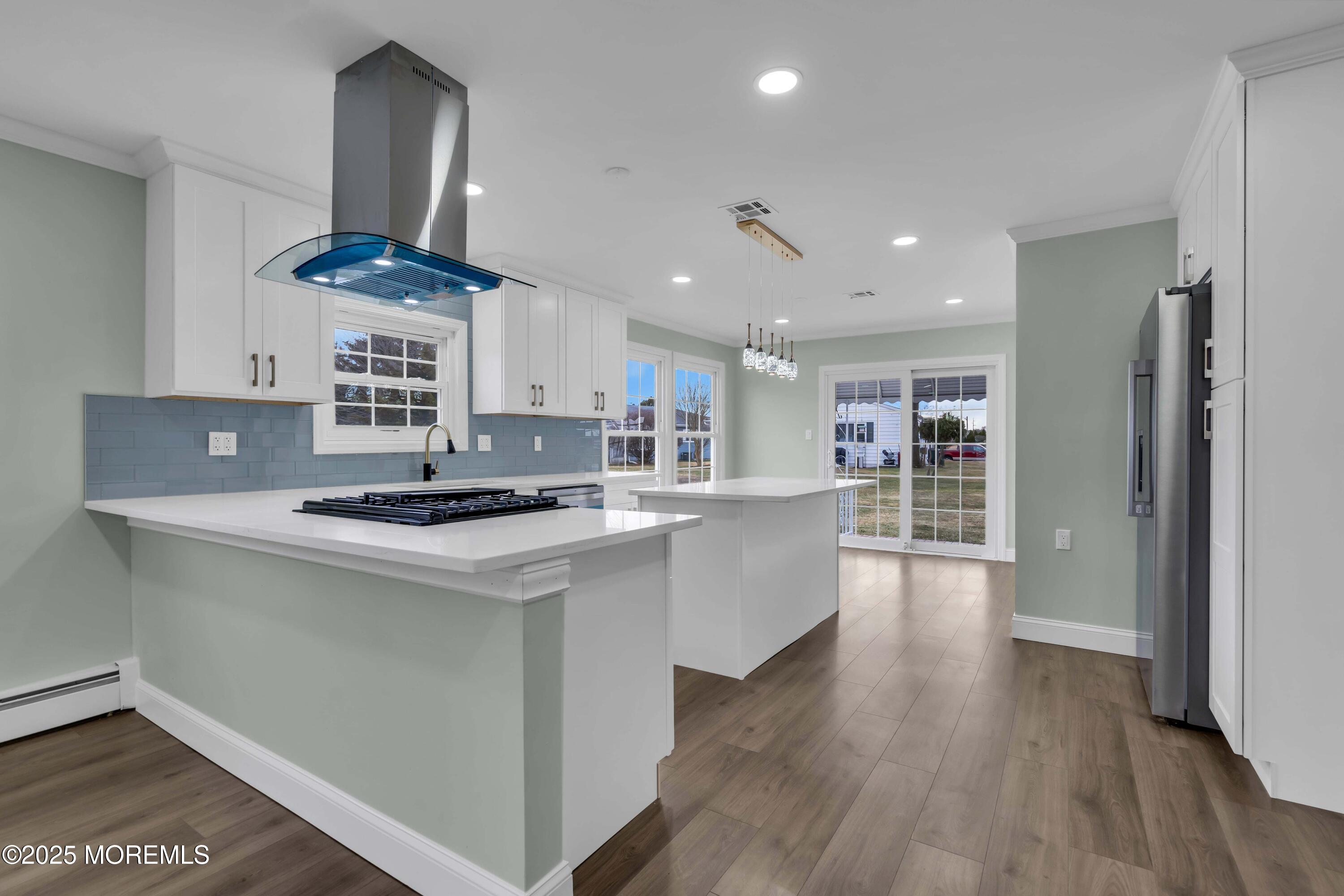 10 Aztec Court Toms River, NJ 08757 - Photo 28 of 57 a kitchen with stainless steel appliances granite countertop a sink a stove and a wooden floors