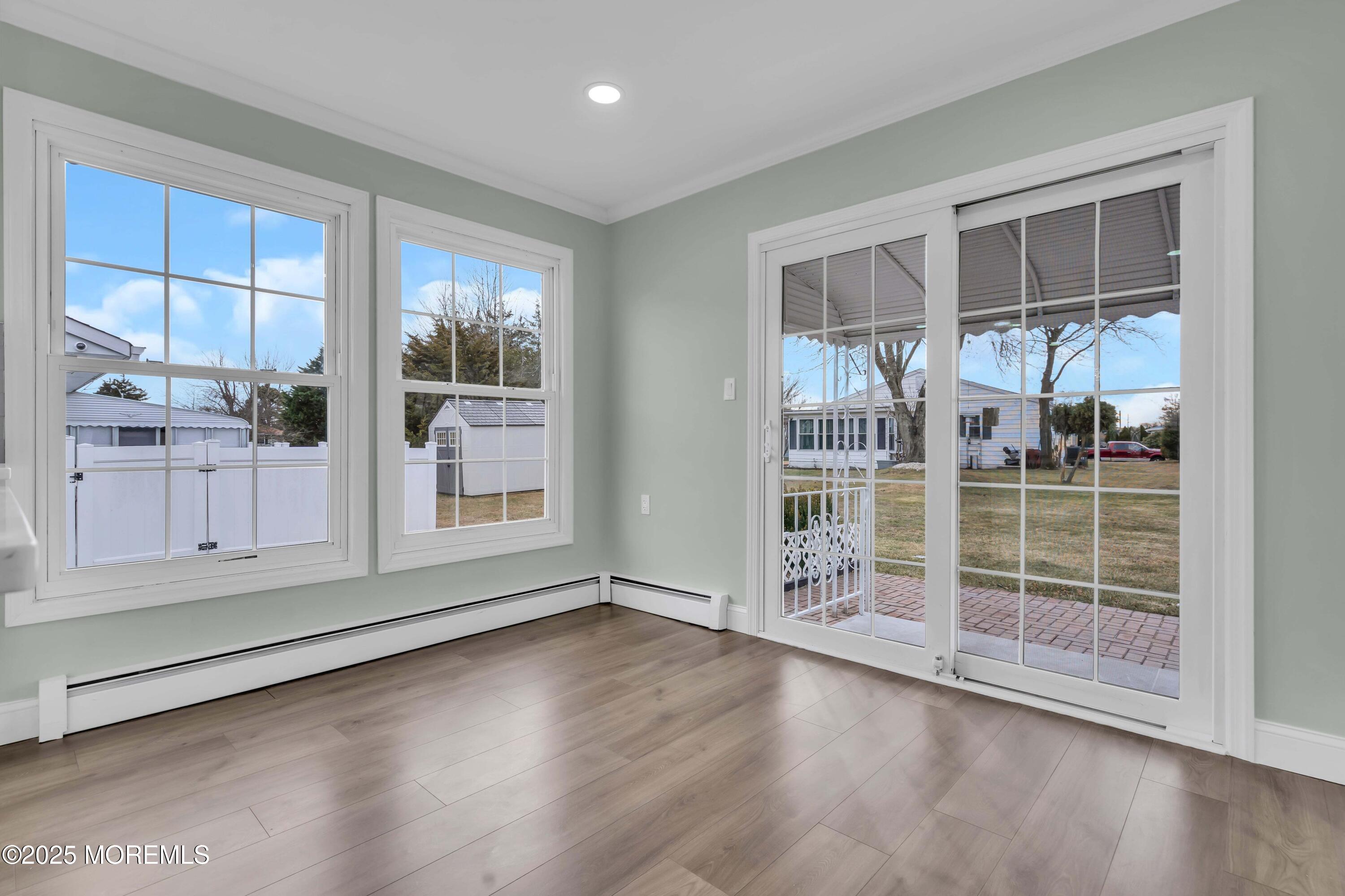 10 Aztec Court Toms River, NJ 08757 - Photo 33 of 57 an empty room with wooden floor and windows