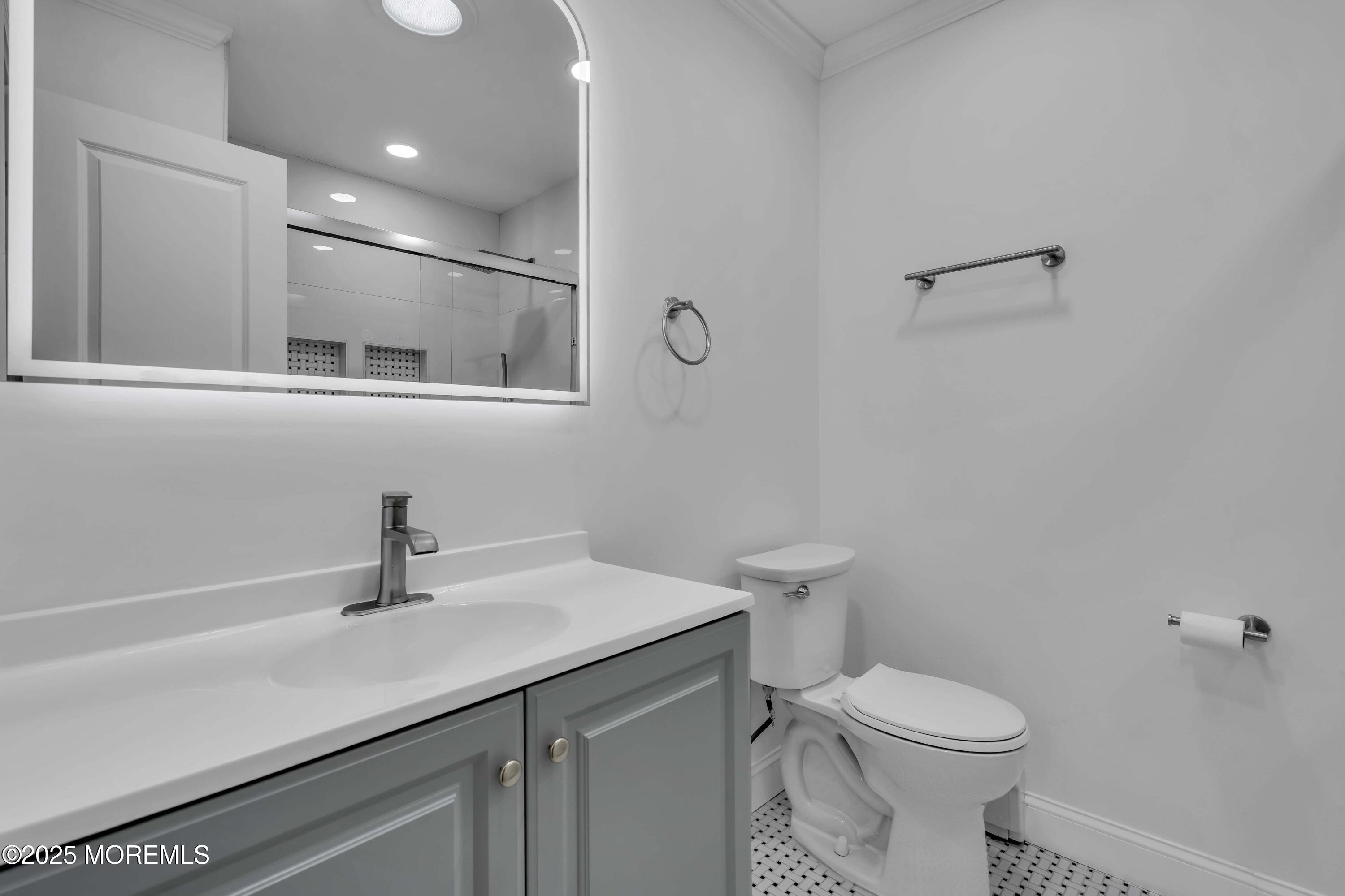 10 Aztec Court Toms River, NJ 08757 - Photo 42 of 57 a bathroom with a sink a toilet and a mirror