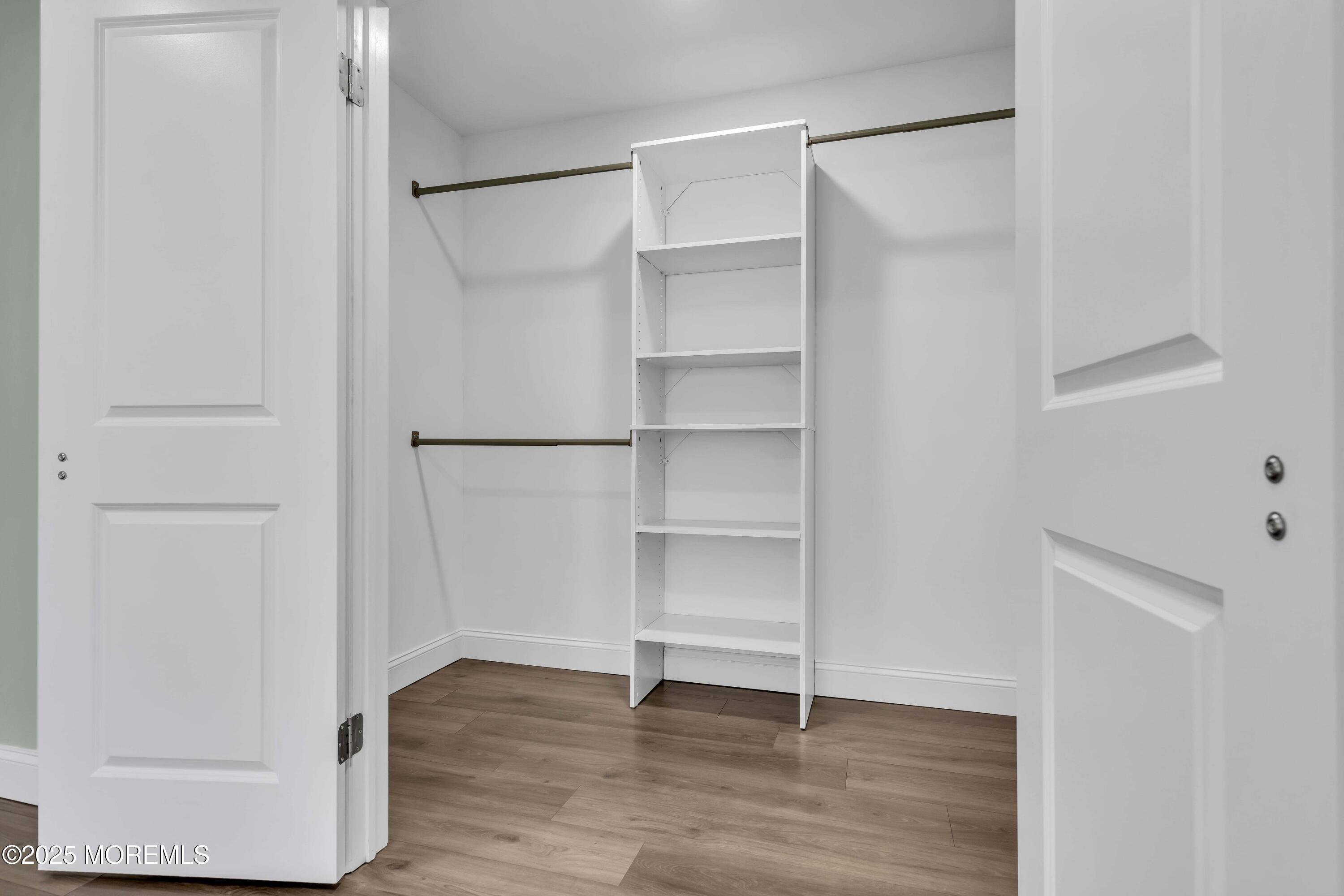 10 Aztec Court Toms River, NJ 08757 - Photo 49 of 57 a view of an empty walk in closet with wooden floor