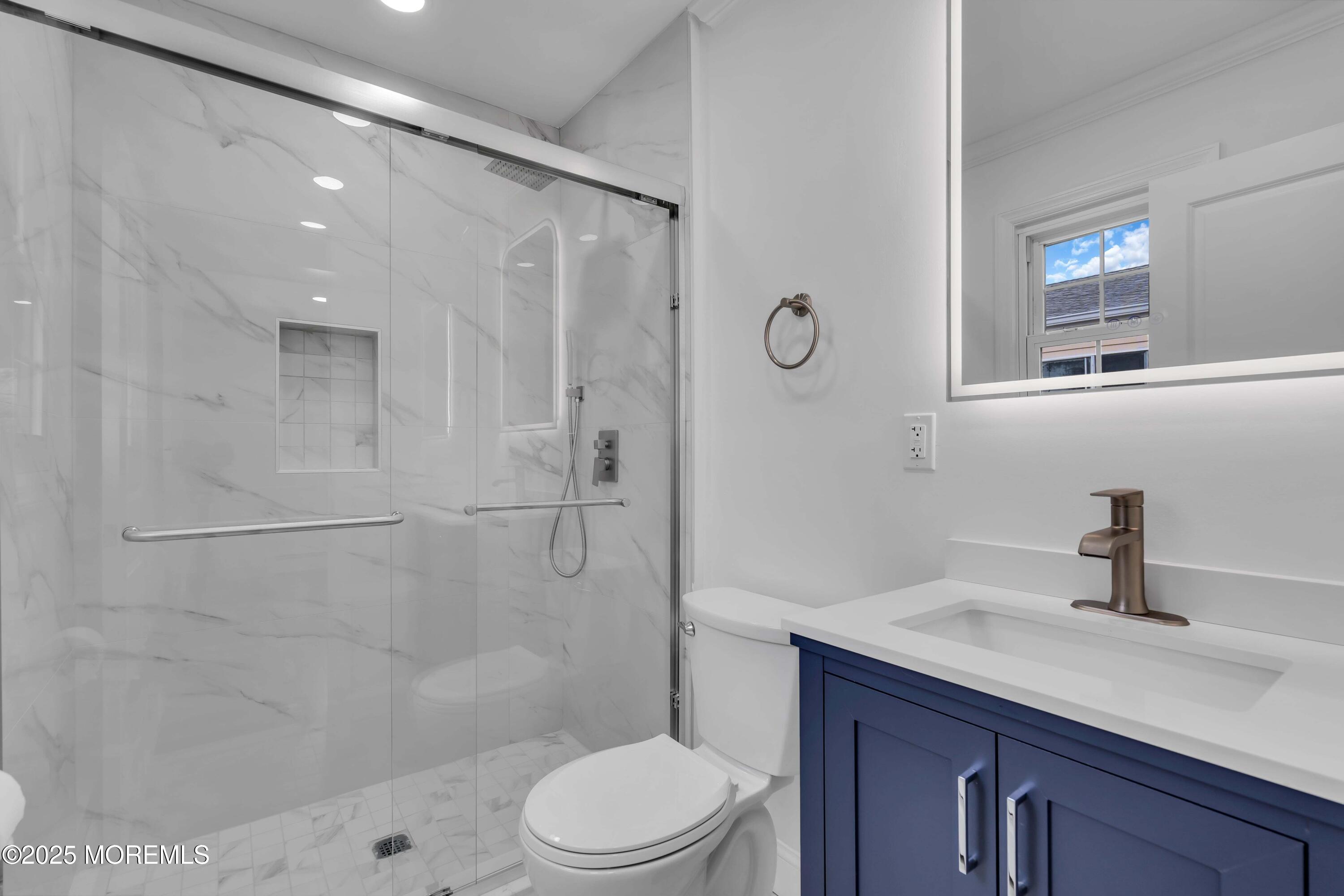 10 Aztec Court Toms River, NJ 08757 - Photo 50 of 57 a bathroom with a sink a toilet and shower