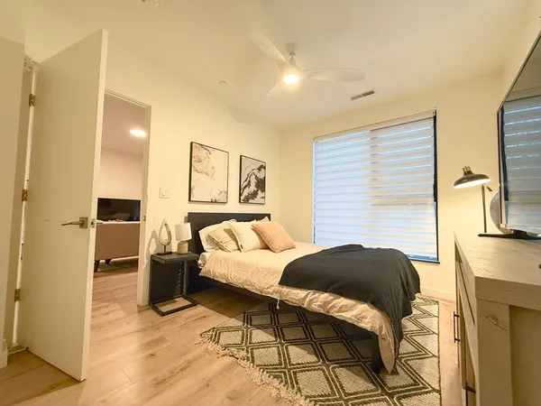 a bedroom with a bed and a couch