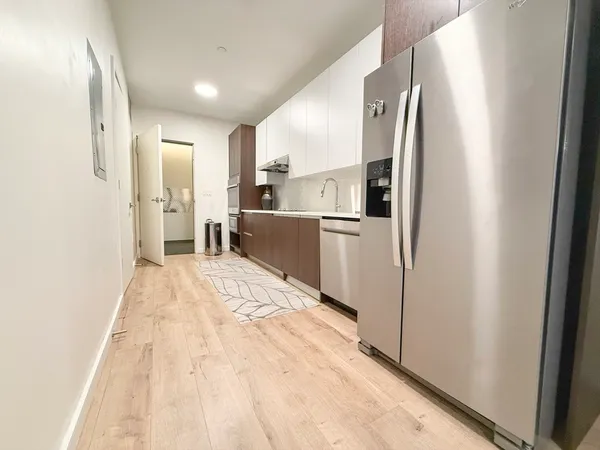 a kitchen with stainless steel appliances a refrigerator and a stove