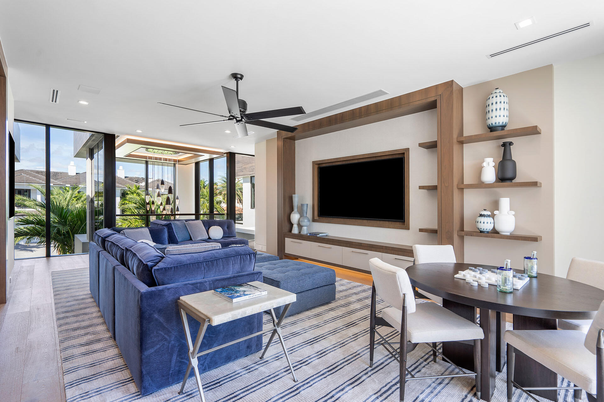 500 East Alexander Palm Road Boca Raton, FL 33432 - Photo 51 of 89 a living room with furniture a flat screen tv and a large window