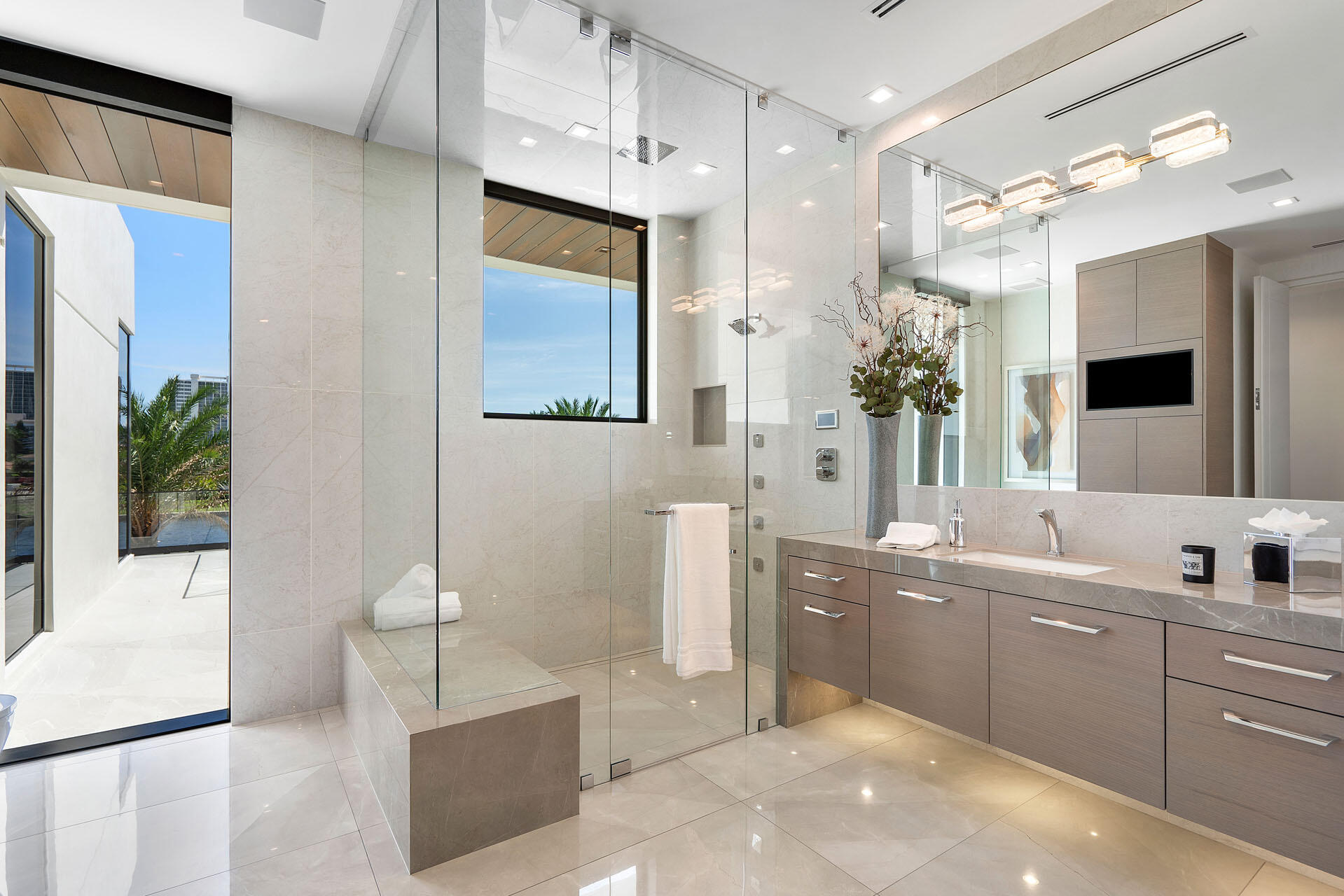 500 East Alexander Palm Road Boca Raton, FL 33432 - Photo 60 of 89 a large bathroom with a double vanity sink a large mirror and a bathtub