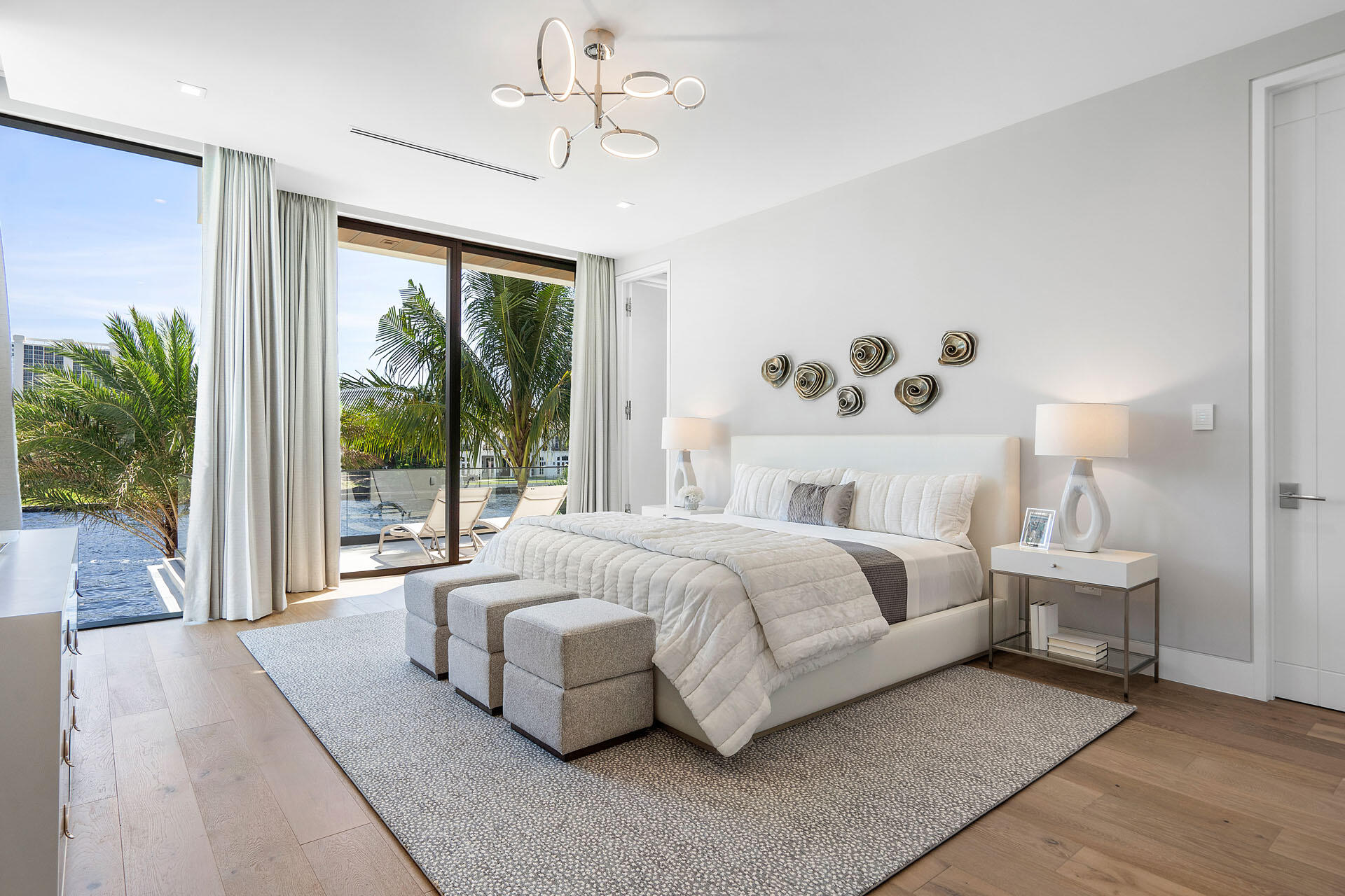 500 East Alexander Palm Road Boca Raton, FL 33432 - Photo 62 of 89 a bedroom with a large bed and a chandelier