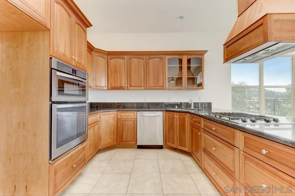 3650 Emma Road Vista, CA 92084 - Photo 13 of 25 a kitchen with stainless steel appliances granite countertop a refrigerator and a stove top oven