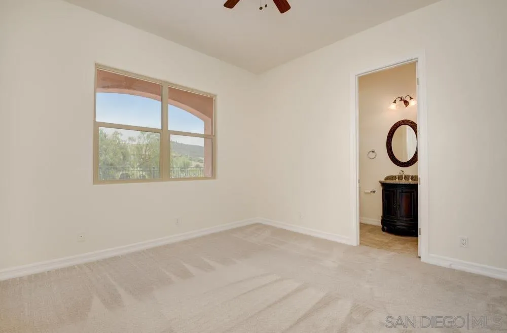 3650 Emma Road Vista, CA 92084 - Photo 20 of 25 an empty room with a window and a ceiling fan