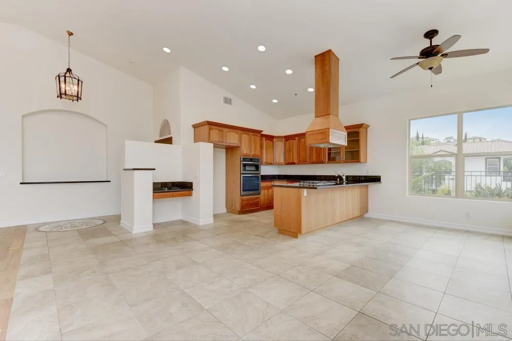 3650 Emma Road Vista, CA 92084 - Photo 10 of 25 a kitchen with stainless steel appliances a refrigerator sink and cabinets