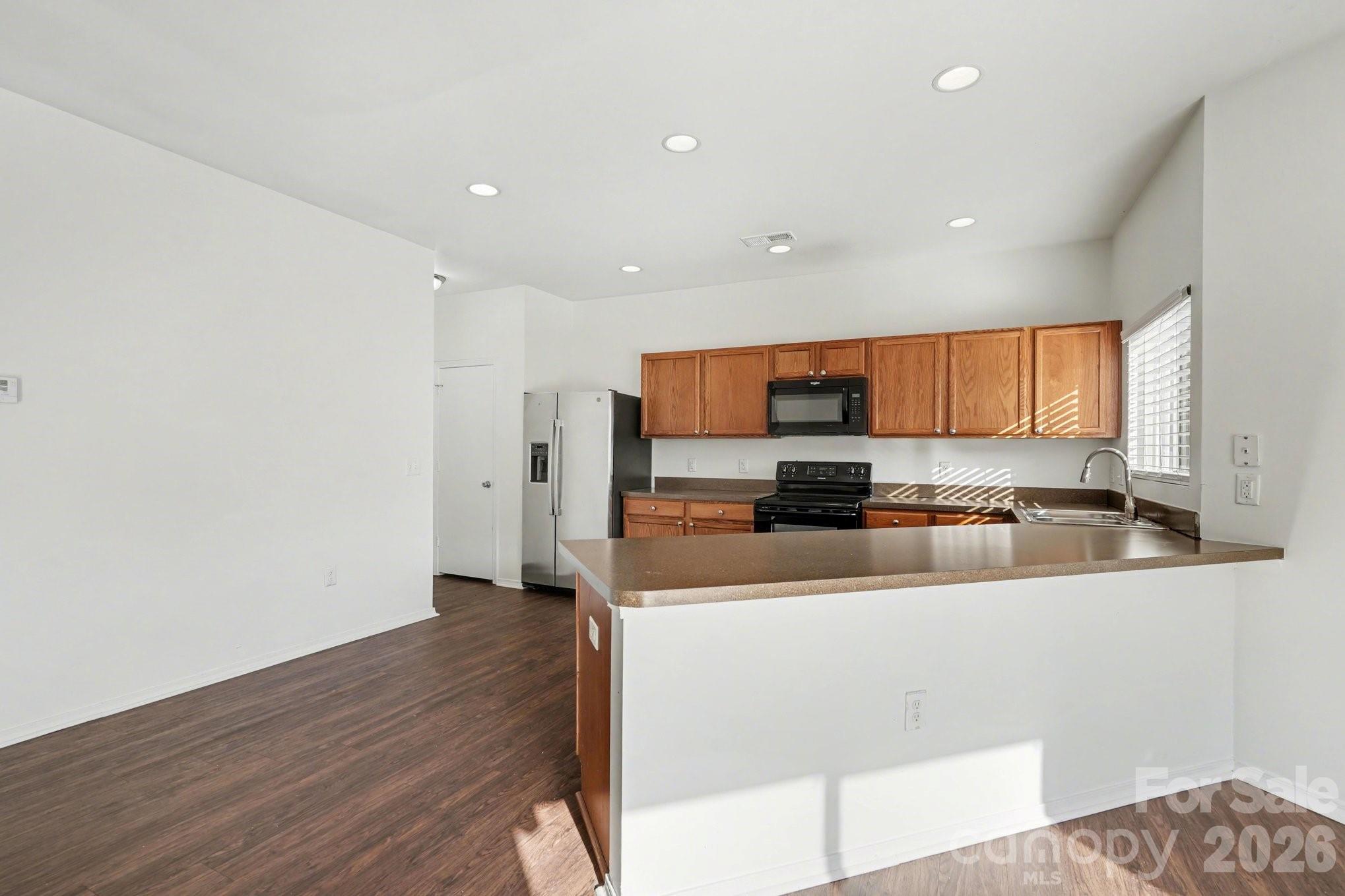 4400 Kiddle Lane Monroe, NC 28110 - Photo 12 of 28 a large kitchen with stainless steel appliances a large counter top a stove and a refrigerator