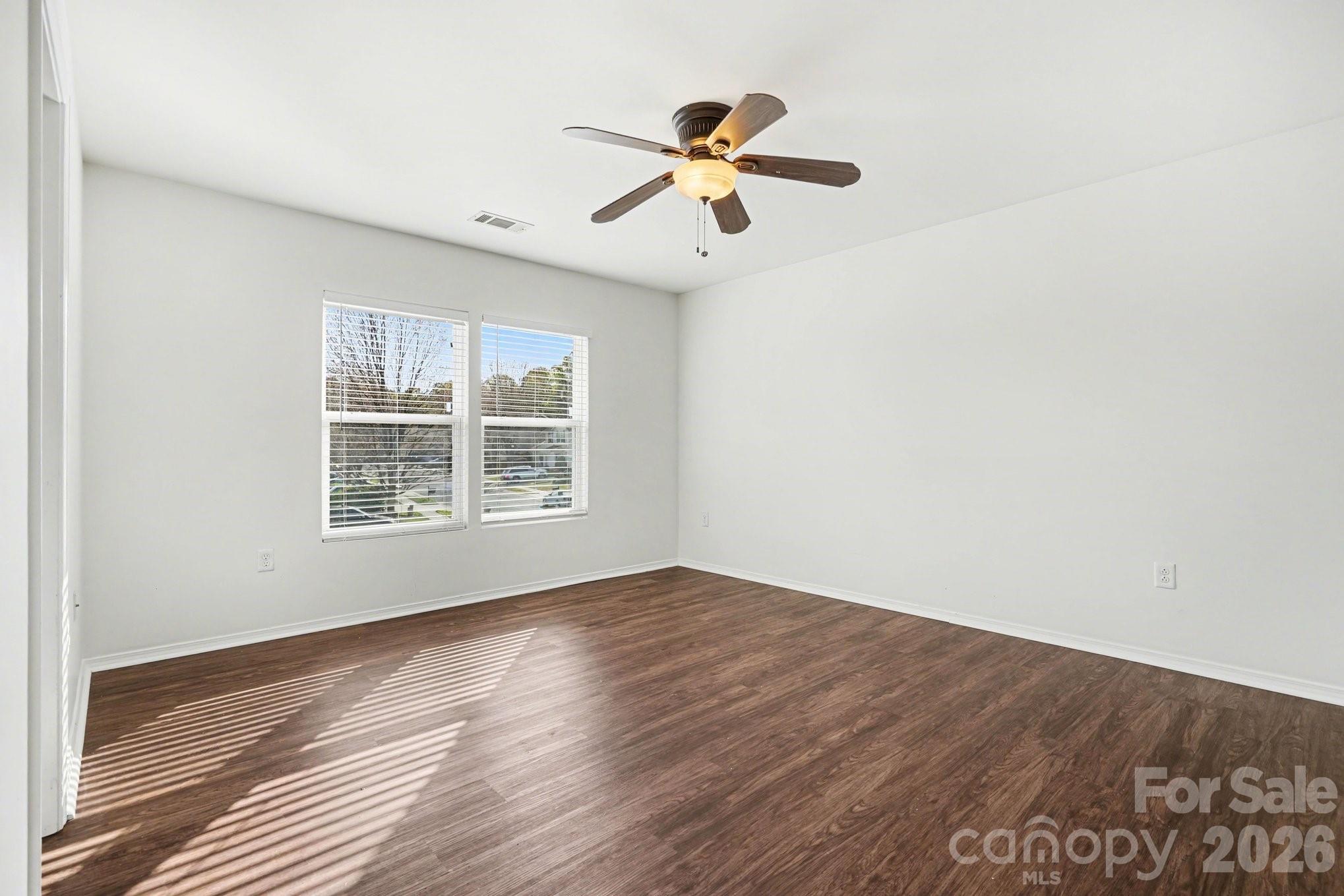 4400 Kiddle Lane Monroe, NC 28110 - Photo 19 of 28 a view of an empty room with wooden floor and a window