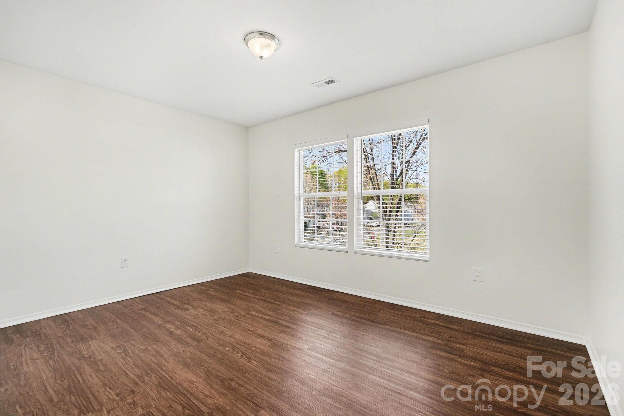 4400 Kiddle Lane Monroe, NC 28110 - Photo 24 of 28 an empty room with wooden floor and windows