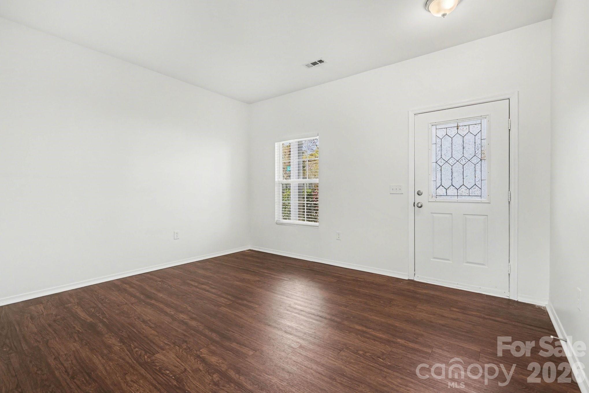 4400 Kiddle Lane Monroe, NC 28110 - Photo 3 of 28 an empty room with wooden floor and windows