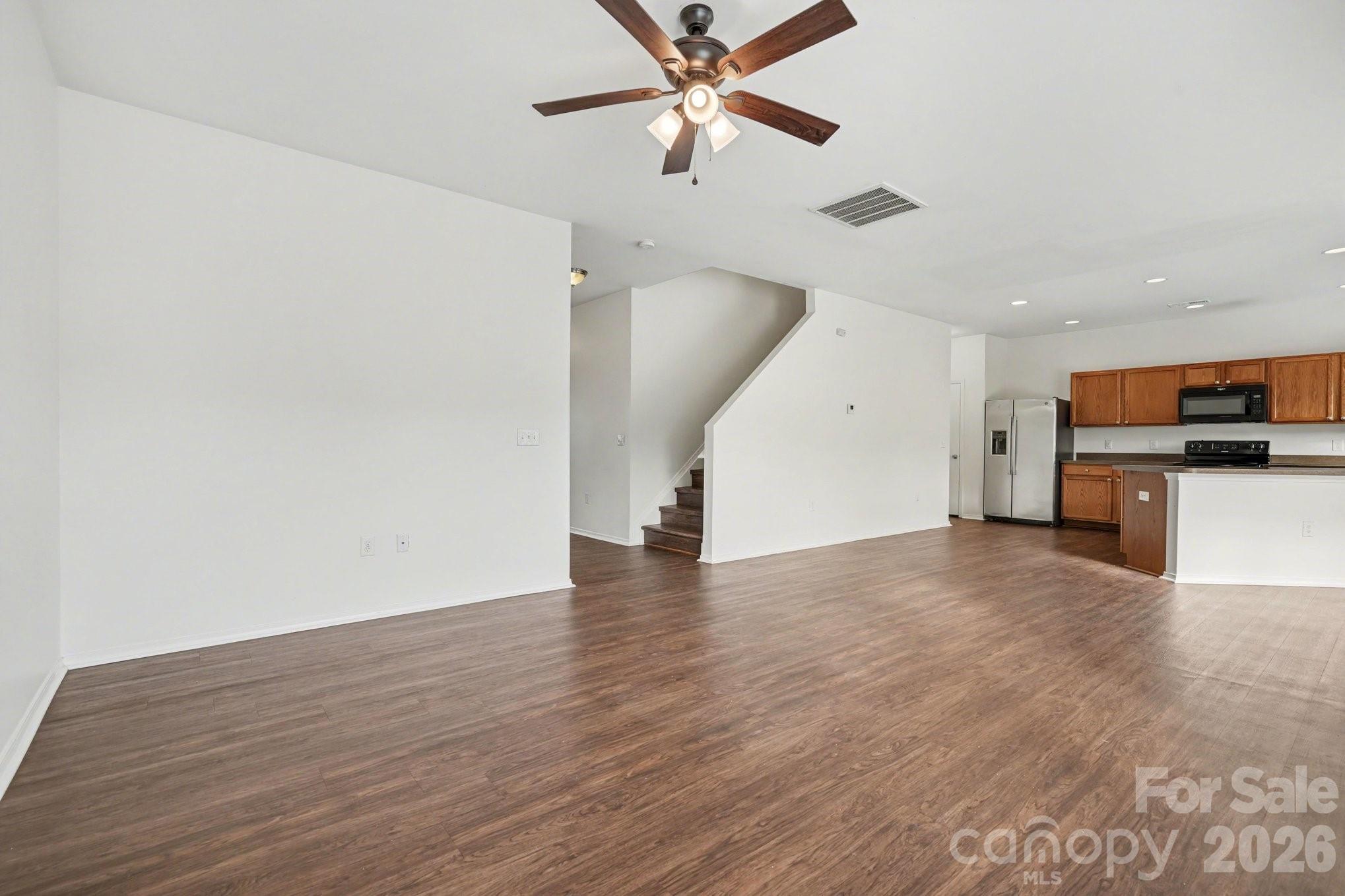 4400 Kiddle Lane Monroe, NC 28110 - Photo 8 of 28 a view of empty room with wooden floor and ceiling fan