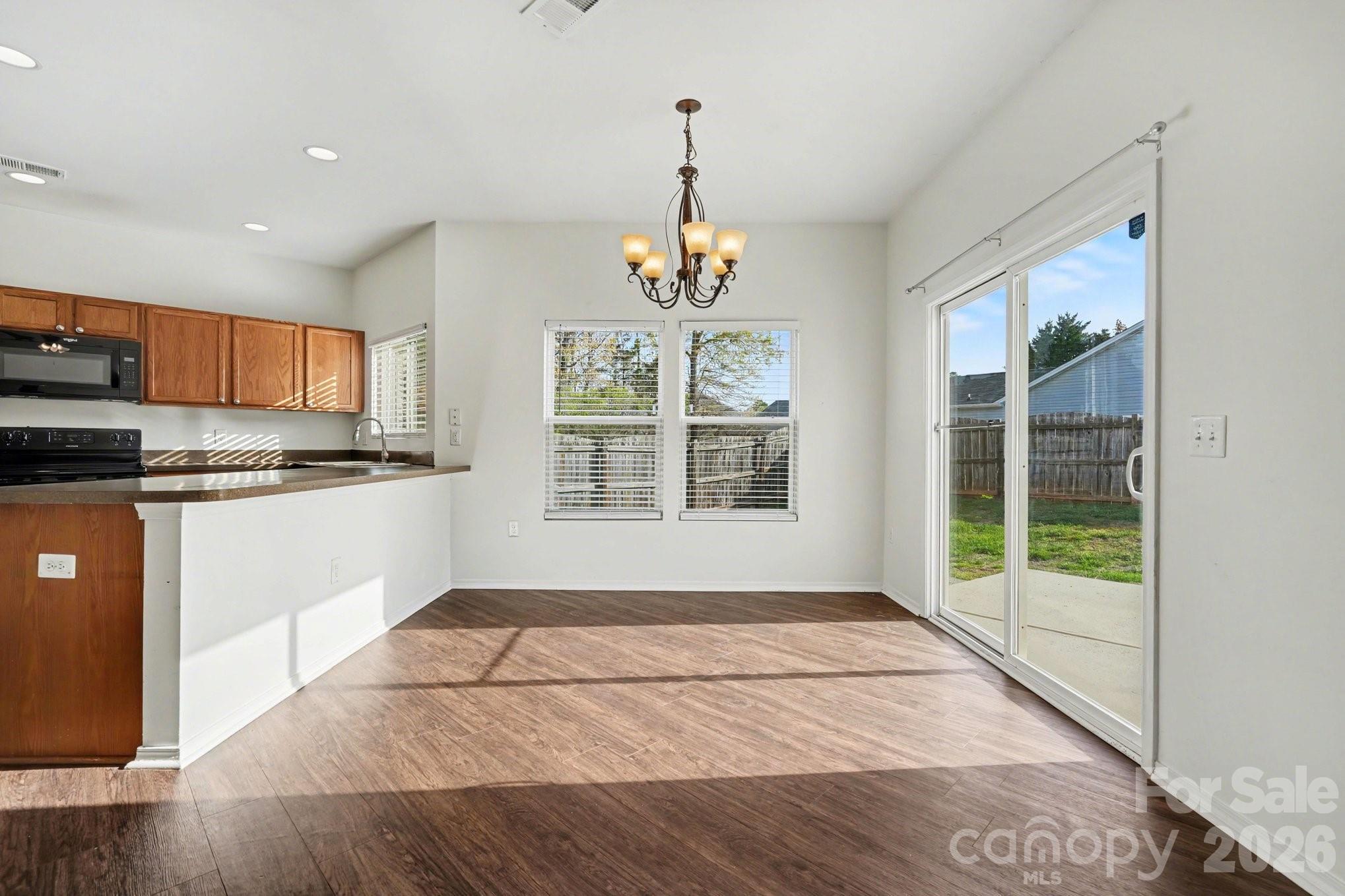 4400 Kiddle Lane Monroe, NC 28110 - Photo 10 of 28 a kitchen with stainless steel appliances granite countertop a stove a sink and a refrigerator