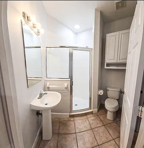 a bathroom with a sink toilet and a mirror