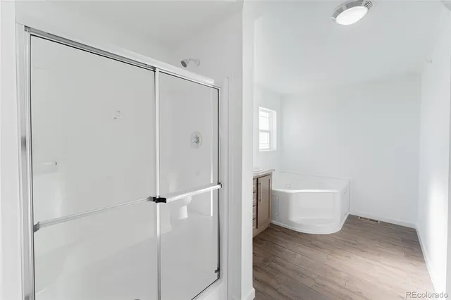 a bathroom with a bathtub and a shower