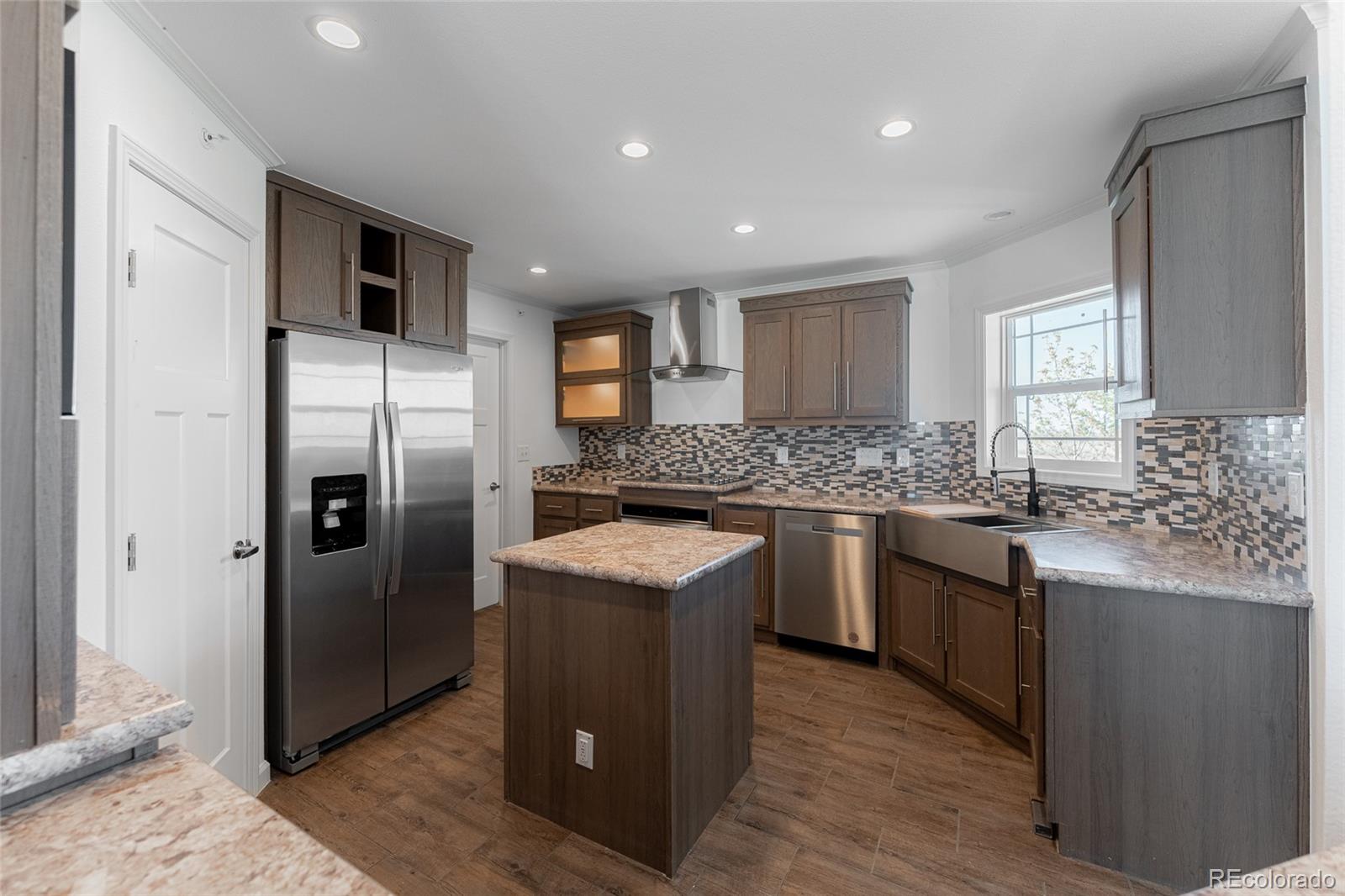 9 Timberlake Road Byers, CO 80103 - Photo 5 of 28 a kitchen with stainless steel appliances granite countertop a refrigerator a stove a sink and a microwave