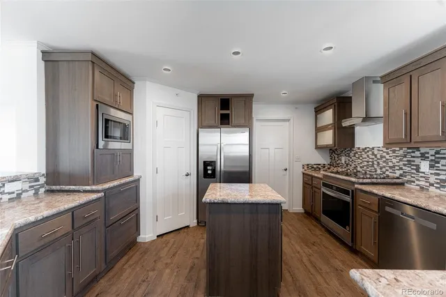 a kitchen with granite countertop stainless steel appliances and wooden cabinets