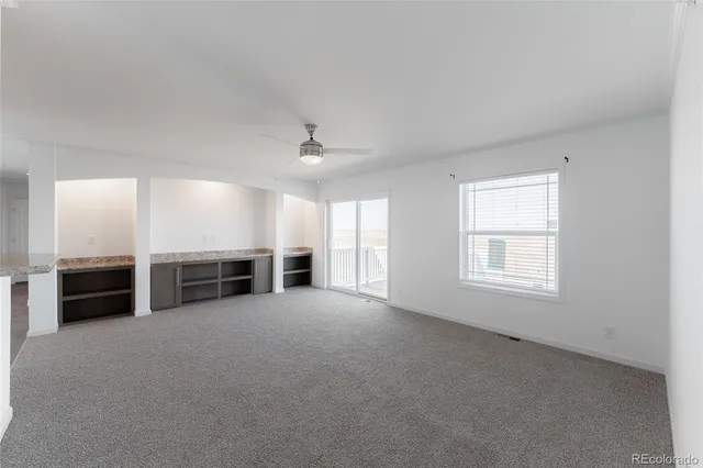 a view of a livingroom with an empty space and a fireplace