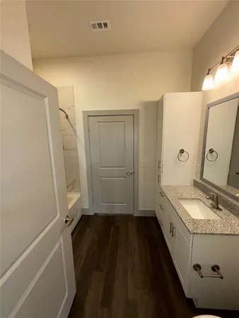 a bathroom with a sink a mirror and a shower