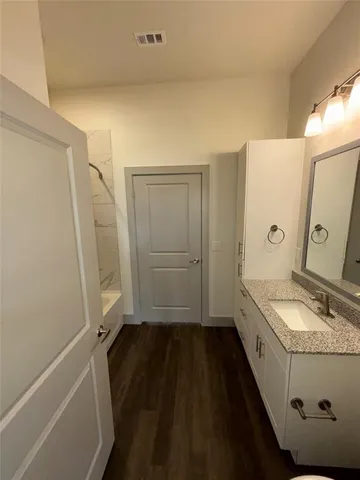 a bathroom with a sink a mirror and a shower